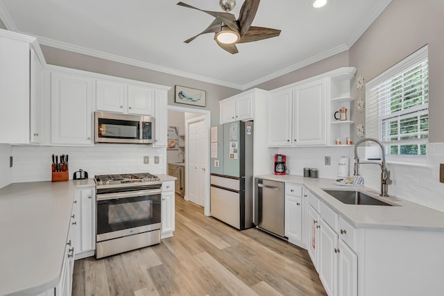 597 Avalon Blvd, Miramar Beach, FL 32550 - kitchen with a sink, a ceiling fan, white cabinets, and stainless steel appliances