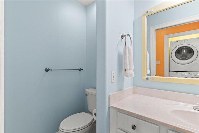 8054 Gulf Blvd, Navarre, FL 32566 - bathroom featuring toilet, stacked washer and clothes dryer, and vanity