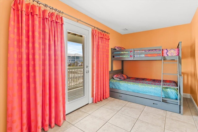 8054 Gulf Blvd, Navarre, FL 32566 - tiled bedroom featuring access to outside and baseboards