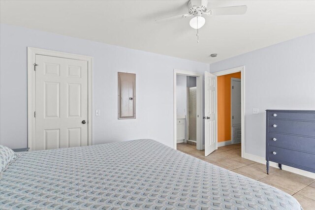 8054 Gulf Blvd, Navarre, FL 32566 - bedroom with baseboards, a ceiling fan, light tile patterned floors, and electric panel