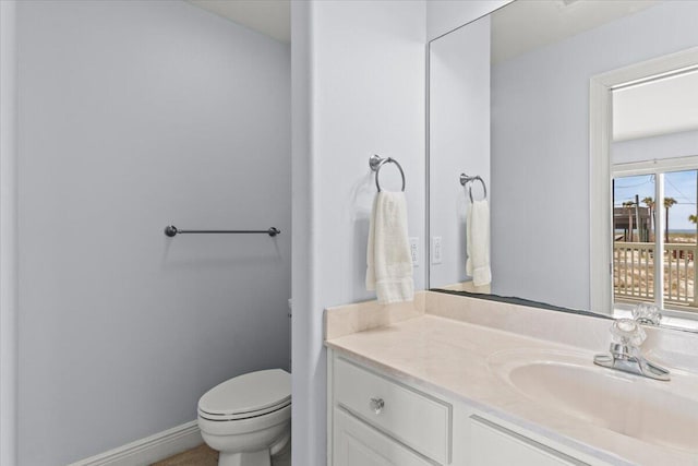 8054 Gulf Blvd, Navarre, FL 32566 - bathroom featuring toilet, baseboards, and vanity