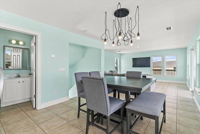 8054 Gulf Blvd, Navarre, FL 32566 - dining room featuring a notable chandelier, baseboards, visible vents, and light tile patterned floors