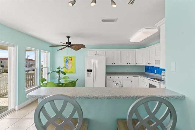 8054 Gulf Blvd, Navarre, FL 32566 - kitchen featuring white appliances, a ceiling fan, white cabinets, and visible vents