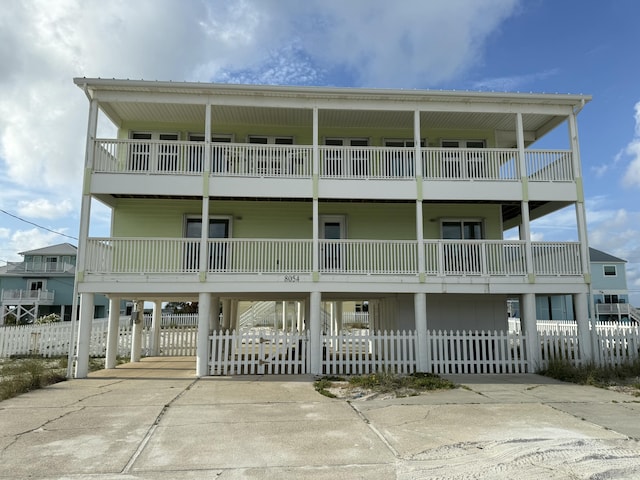 8054 Gulf Blvd, Navarre, FL 32566 - view of building exterior with a carport, driveway, and fence private yard