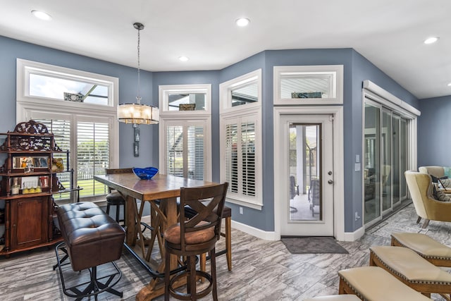 dining area featuring recessed lighting, baseboards, and a chandelier