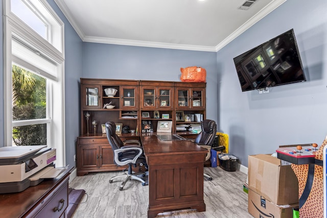 home office with baseboards, visible vents, ornamental molding, and light wood-type flooring