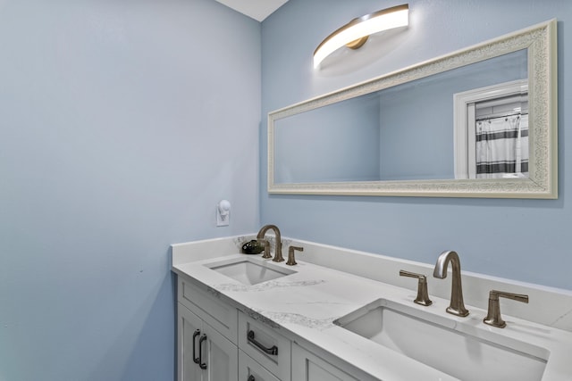 full bathroom featuring double vanity and a sink