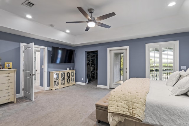 carpeted bedroom with visible vents, access to exterior, baseboards, recessed lighting, and a tray ceiling
