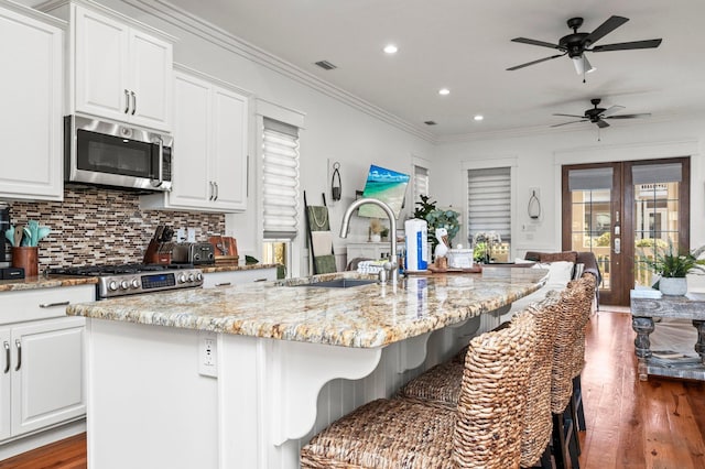 50 Cinnamon Fern Ln, Santa Rosa Beach, FL 32459 - kitchen with a sink, dark wood finished floors, recessed lighting, white cabinets, and appliances with stainless steel finishes