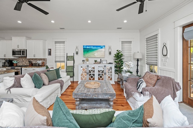 50 Cinnamon Fern Ln, Santa Rosa Beach, FL 32459 - living area featuring visible vents, light wood-style flooring, a ceiling fan, and ornamental molding