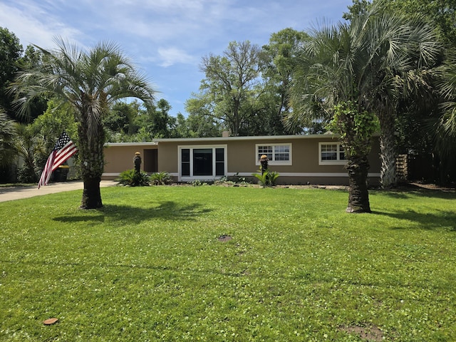 361 NE Gardner Dr, Fort Walton Beach, FL 32548 - ranch-style house with stucco siding, driveway, and a front lawn