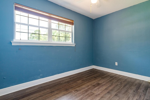 361 NE Gardner Dr, Fort Walton Beach, FL 32548 - unfurnished room with baseboards, dark wood-style flooring, and a ceiling fan