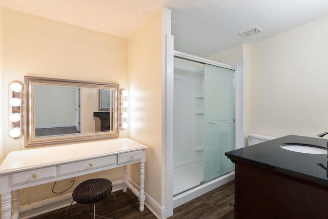 361 NE Gardner Dr, Fort Walton Beach, FL 32548 - bathroom with vanity, wood finished floors, a shower stall, and a textured ceiling