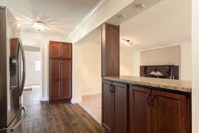 361 NE Gardner Dr, Fort Walton Beach, FL 32548 - kitchen featuring stainless steel fridge with ice dispenser, a textured ceiling, dark wood finished floors, light stone countertops, and open floor plan