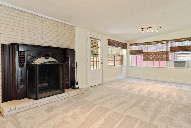 361 NE Gardner Dr, Fort Walton Beach, FL 32548 - unfurnished living room featuring a textured ceiling, carpet floors, a brick fireplace, cooling unit, and baseboards