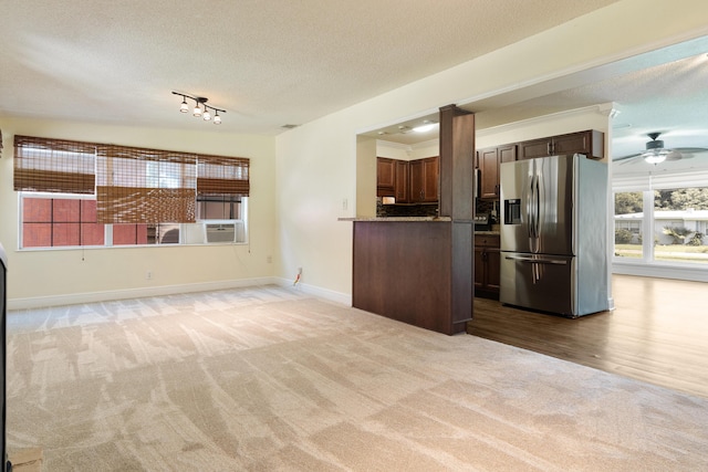 361 NE Gardner Dr, Fort Walton Beach, FL 32548 - unfurnished living room with light colored carpet, a textured ceiling, baseboards, ceiling fan, and rail lighting