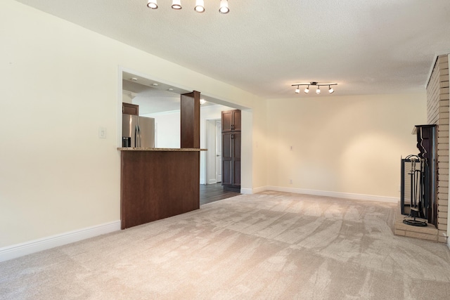 361 NE Gardner Dr, Fort Walton Beach, FL 32548 - unfurnished living room featuring carpet flooring, baseboards, and a textured ceiling