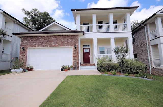 neoclassical / greek revival house featuring a front lawn, a balcony, brick siding, a porch, and driveway