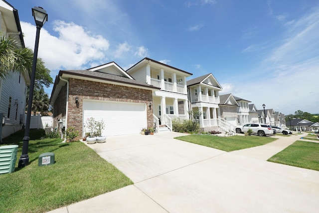 view of front of property featuring concrete driveway, brick siding, a residential view, and a front yard