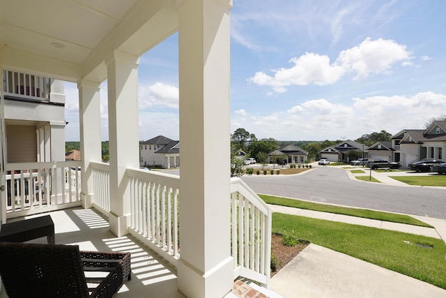 balcony with covered porch and a residential view