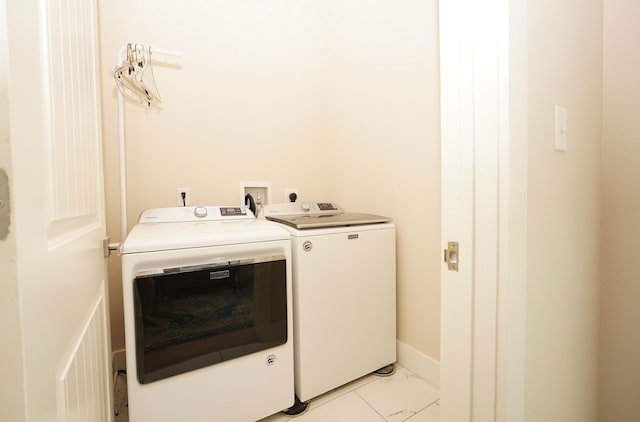 washroom with laundry area, marble finish floor, and independent washer and dryer