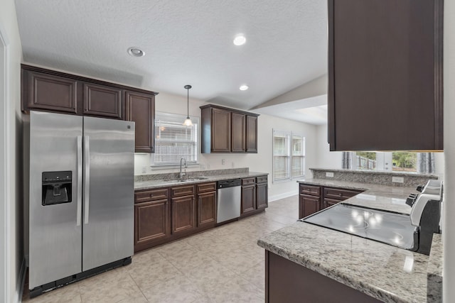 2690 Hartman Ct, Navarre, FL 32566 - kitchen featuring pendant lighting, light tile patterned flooring, a sink, dark brown cabinetry, and appliances with stainless steel finishes