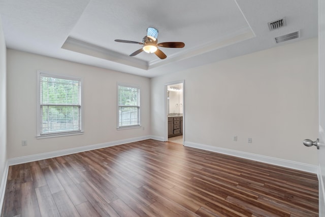 2690 Hartman Ct, Navarre, FL 32566 - spare room with a ceiling fan, a tray ceiling, visible vents, and wood finished floors