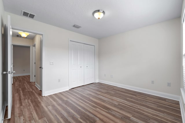 2690 Hartman Ct, Navarre, FL 32566 - unfurnished bedroom featuring baseboards, a closet, visible vents, and dark wood-style floors