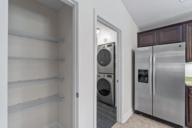 2690 Hartman Ct, Navarre, FL 32566 - laundry room featuring baseboards, laundry area, stacked washer / drying machine, and light tile patterned flooring