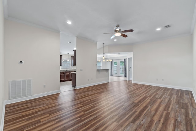 2690 Hartman Ct, Navarre, FL 32566 - unfurnished living room featuring crown molding, ceiling fan with notable chandelier, dark wood-style floors, and visible vents