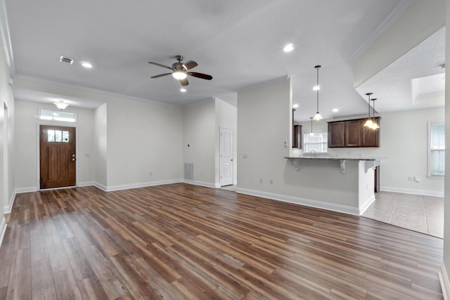 2690 Hartman Ct, Navarre, FL 32566 - unfurnished living room with ornamental molding, visible vents, ceiling fan, and dark wood-style floors