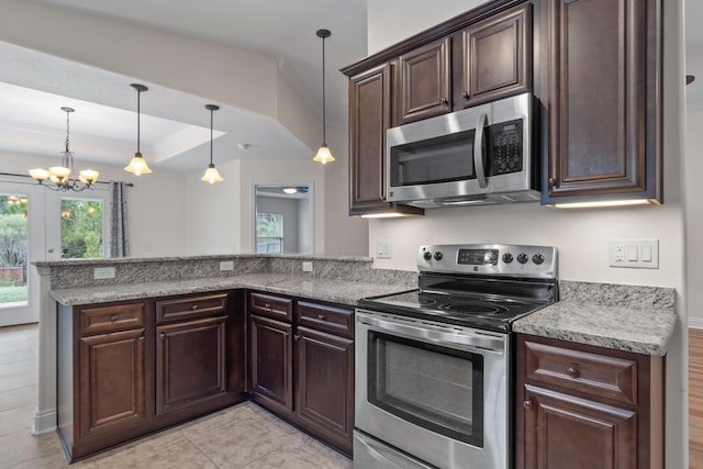 2690 Hartman Ct, Navarre, FL 32566 - kitchen featuring a peninsula, dark brown cabinetry, appliances with stainless steel finishes, and an inviting chandelier
