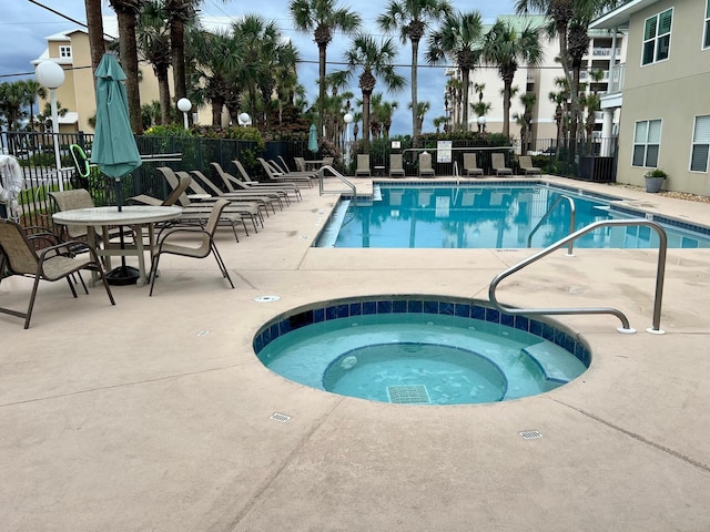 73 Shirah St Unit 106, Destin, FL 32541 - community pool with a hot tub, a patio area, and fence