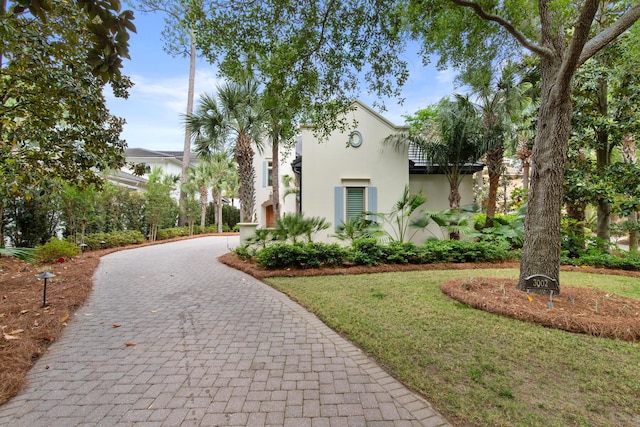 3002 Bay Villas Dr, Miramar Beach, FL 32550 - view of front facade featuring curved driveway and stucco siding