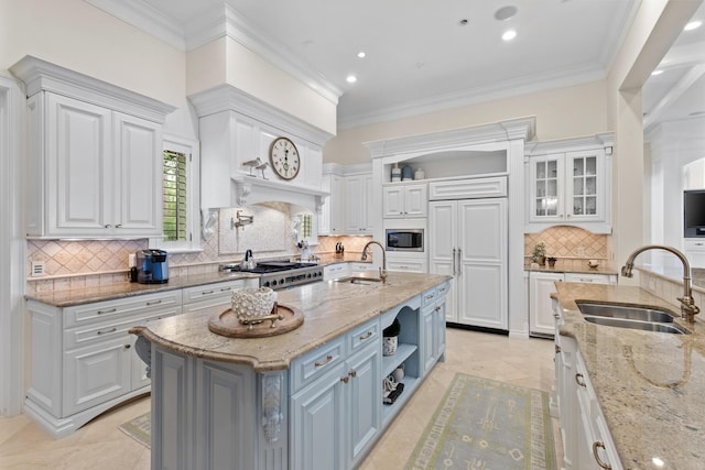 3002 Bay Villas Dr, Miramar Beach, FL 32550 - kitchen with a sink, stainless steel microwave, open shelves, white cabinets, and ornamental molding