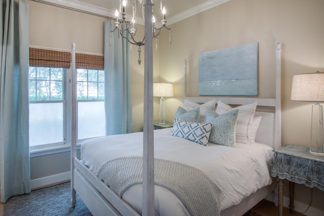 bedroom featuring an inviting chandelier, baseboards, and ornamental molding