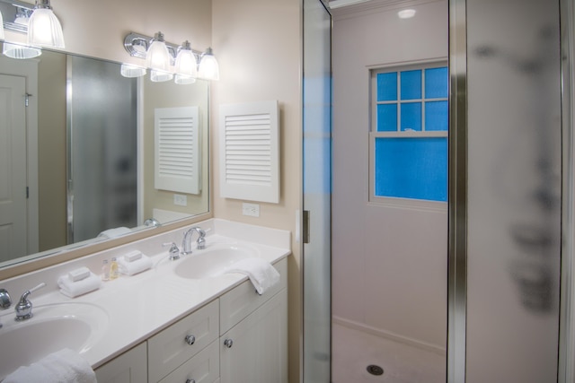 full bathroom with a sink, a shower stall, and double vanity