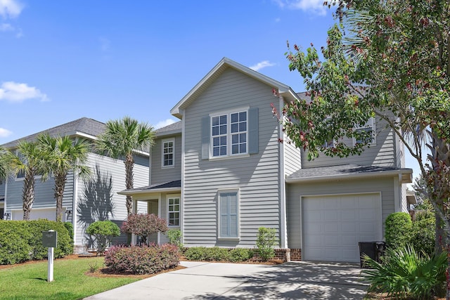 view of front of property with roof with shingles, an attached garage, and concrete driveway