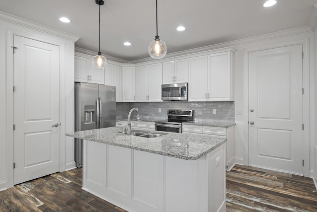 kitchen with white cabinets, appliances with stainless steel finishes, a sink, and dark wood finished floors