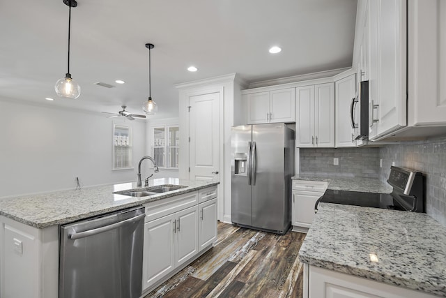 kitchen with a sink, decorative backsplash, white cabinets, and stainless steel appliances