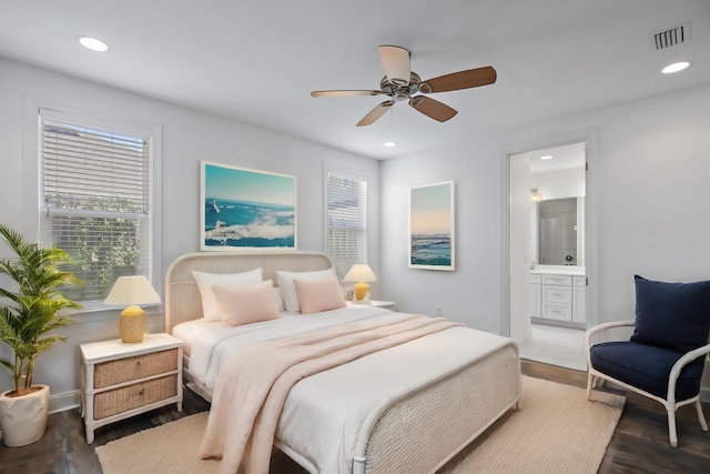 bedroom with ensuite bathroom, recessed lighting, and visible vents