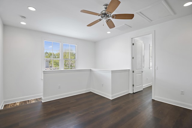 empty room with a ceiling fan, baseboards, visible vents, and wood finished floors