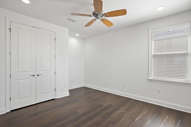 unfurnished bedroom with baseboards, recessed lighting, and dark wood-type flooring