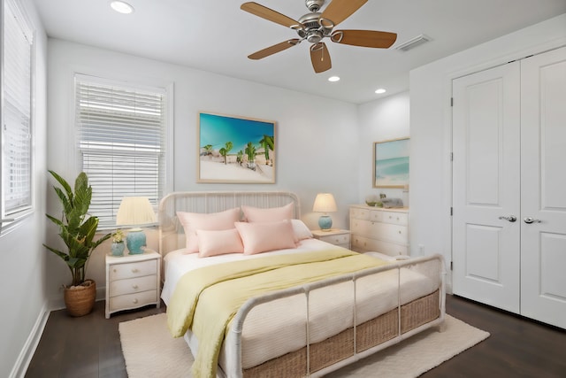 bedroom with visible vents, recessed lighting, dark wood-type flooring, and a closet