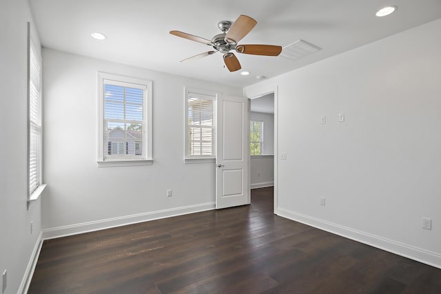 unfurnished room with baseboards, recessed lighting, and dark wood-style flooring
