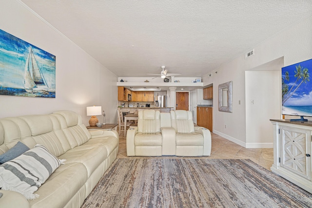 100 Gulf Shore Dr Unit 202, Destin, FL 32541 - living room featuring visible vents, baseboards, ceiling fan, a textured ceiling, and light tile patterned floors