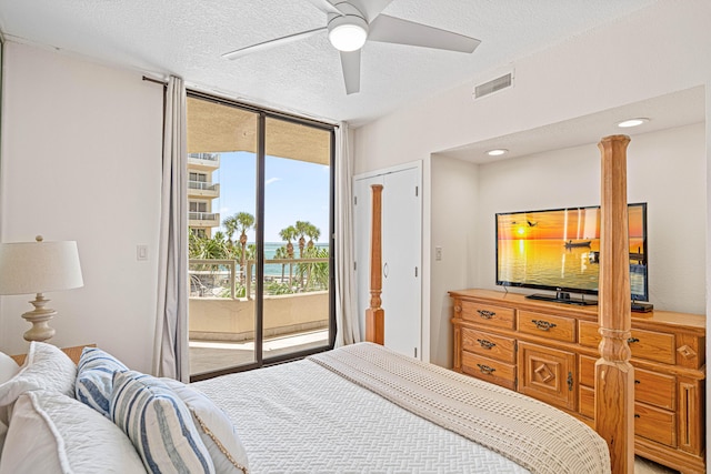 100 Gulf Shore Dr Unit 202, Destin, FL 32541 - bedroom with a wall of windows, ceiling fan, a textured ceiling, visible vents, and access to outside