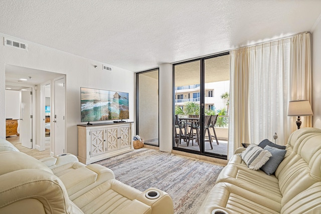 100 Gulf Shore Dr Unit 202, Destin, FL 32541 - living area featuring visible vents, a textured ceiling, and floor to ceiling windows