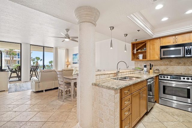 100 Gulf Shore Dr Unit 202, Destin, FL 32541 - kitchen featuring stone tile flooring, a textured ceiling, tasteful backsplash, a sink, and stainless steel appliances