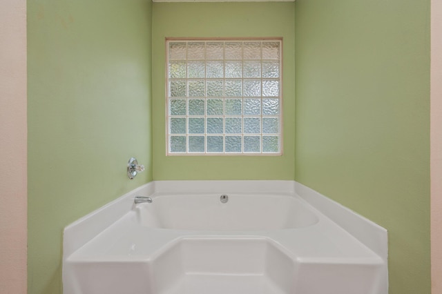 bathroom with a garden tub